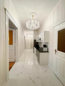 a kitchen with a large marble floor and a chandelier at Stupartska 9 - Premium Old Town Residence in Prague