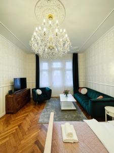 a living room with a couch and a chandelier at Stupartska 9 - Premium Old Town Residence in Prague