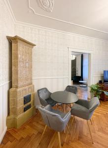 a living room with a table and chairs and a fireplace at Stupartska 9 - Premium Old Town Residence in Prague