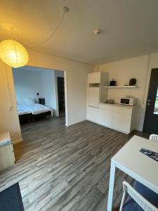 an empty living room with a bed and a table at KragenæsHus in Torrig