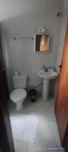 a bathroom with a toilet and a sink at Pousada Águia da Serra Gramado 1 in Gramado