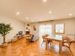 a living room with a table and chairs and a couch at Comfortable apartment in Viana do Castelo in Viana do Castelo