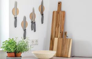 a kitchen counter with utensils hanging on a wall at Pet Friendly Apartment in Lembruch