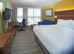 a hotel room with a bed and a television at Holiday Inn Express Nags Head Oceanfront, an IHG Hotel in Nags Head