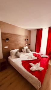 a hotel room with two beds with red curtains at Jeff Hotel in Paris