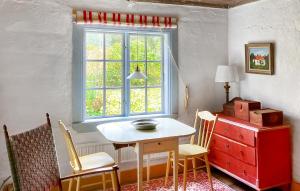 a table and chairs in a room with a window at Lovely Home In Vittinge With Wifi 