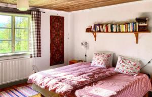 a bedroom with a bed with a pink comforter at Lovely Home In Vittinge With Wifi 