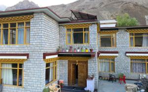 a house with a mountain in the background at Namkha Homestay by StayApart in Tabo
