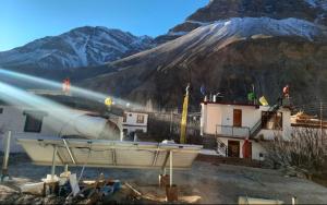 a building with a mountain in the background at Namkha Homestay by StayApart in Tabo +12 photos