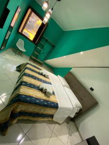 a large bed in a room with a green wall at Sweet Dream in Caserta