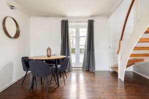 a dining room with a table and chairs at The Canada Water Apartments in London