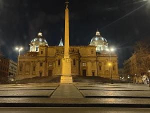 a building with a obelisk in front of it at night at Biancorèroma B&B in Rome