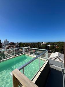 a swimming pool on the roof of a building at Casa Pancha in Pinamar