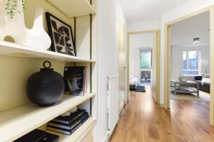 a living room with a vase on a shelf at 1 Bed Garden Flat in Belsize Park next to station! in London