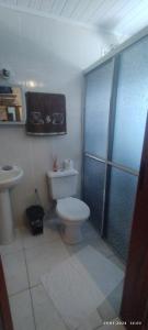 a bathroom with a toilet and a sink and a shower at Pousada Águia da Serra Gramado 1 in Gramado