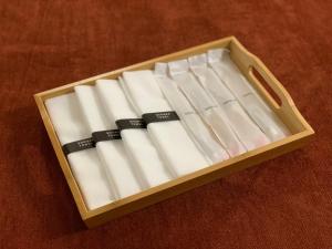 a wooden box filled with white cigarettes on a table at Stay Gongyu Nonhyeon in Seoul