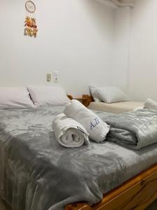 two beds with towels on them in a bedroom at Alexandra Studios in Néos Pírgos