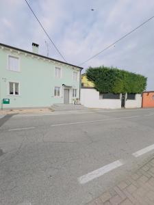 an empty street in front of a white building at La casa verde in Beccacivetta