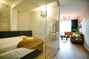 a bedroom with a bed and a glass shower at Apartamenty Laguna Beskidów - A67 in Zarzecze