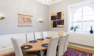 a dining room with a wooden table and chairs at Royal Mile Apartments in Edinburgh
