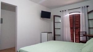 En eller flere senge i et værelse på Hotel Moinho de Pedra