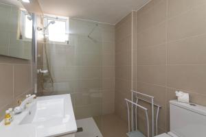 a bathroom with a sink and a shower at TAC - Fisherman's Beach Apartment in Albufeira