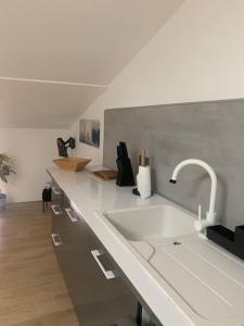 a kitchen counter with a sink and a faucet at Magnifique appartement T2 en Centre VILLAGE in Saverdun