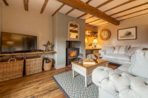 a living room with a couch and a fireplace at Little Star in Ringstead