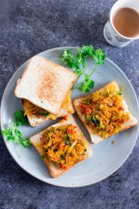 a plate with three slices of toast with vegetables on it at The blessings home stay in Agra