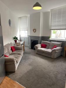 a living room with two couches and a fireplace at CLITHEROE TOWN CENTRE MODERN 2 BED APARTMENT in Clitheroe