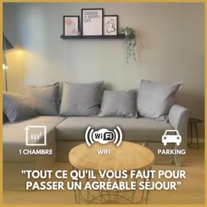 a living room with a couch with avertisement at Le Cocon Urbain *T2* + Parking in Orléans