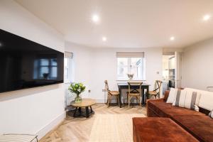 a living room with a couch and a table at Great Escapes Oundle Flat 2 in Oundle
