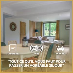 a room with a living room with a couch and a table at La Petite Maison *T3* accès direct Loiret +Parking in Saint-Hilaire-Saint-Mesmin
