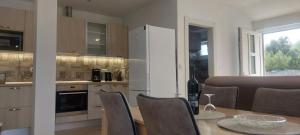 a kitchen and dining room with a table and chairs at Villa A&M in Vinišće