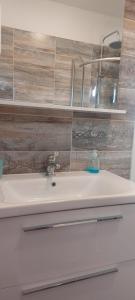 a bathroom with a sink and aaucet at Villa A&M in Vinišće