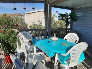 a blue table and chairs on a patio at mobil home in Palavas-les-Flots