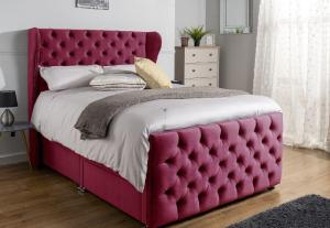 a bed with a red tufted bed frame in a bedroom at Heaven in Cheam