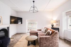 a living room with a couch and a fireplace at Great Escapes Oundle Flat 1 in Oundle