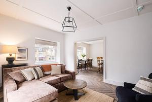a living room with a couch and a table at Great Escapes Oundle Flat 1 in Oundle