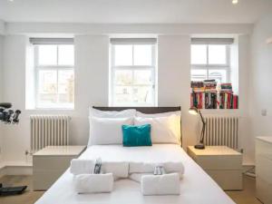 a bedroom with a large white bed with two pillows at Pass the Keys Kingsway Place - Stunning 1 Bedroom Duplex in London