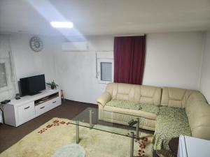 a living room with a couch and a tv at Kouca in Leskovac