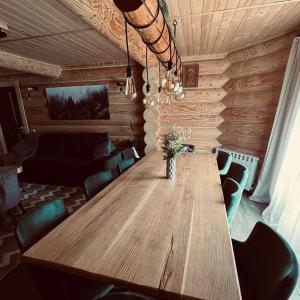 a long wooden table in a room with chairs at BerBen House in Vorokhta