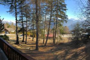 a view of a forest with trees and mountains at Chalet Privé avec vue imprenable sur les alpes in Crans-Montana