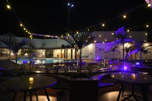 a patio with tables and lights at night at Suryaansh in Pālghar