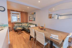 a kitchen and dining room with a table and a couch at Quayside, Fowey in Fowey