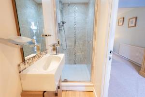 a bathroom with a sink and a shower at Quayside, Fowey in Fowey