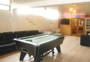 a room with a pool table in a store at Kensal Green Backpackers in London