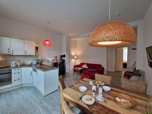 a kitchen and living room with a wooden table and a dining room at Gutshaus Wohnung 3 in Laschendorf
