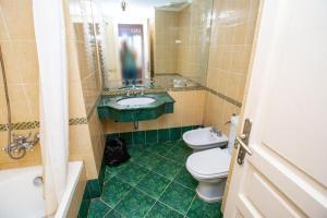 a bathroom with two toilets and a sink at Fourseasons at sanstefano grand plaza in Alexandria +21 photos