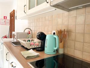 a kitchen counter with a blue mixer on a counter top at Apartment House Prezlc in Kranjska Gora